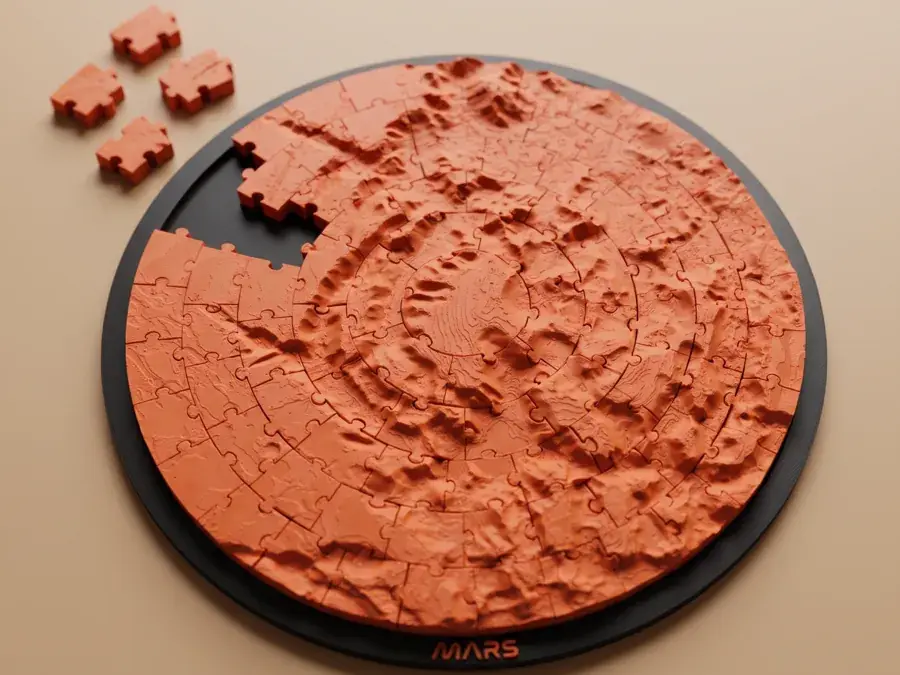 A printed Mars surface jigsaw puzzle in orange, a few pieces set aside.