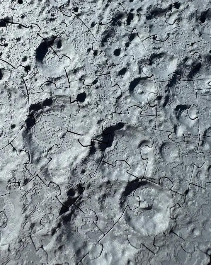 Close-up of printed craters and the seams between puzzle pieces.